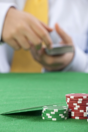 poker player  with a yellow tie serving cards の写真素材