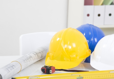 Hardhat  and measuring instruments on blueprint