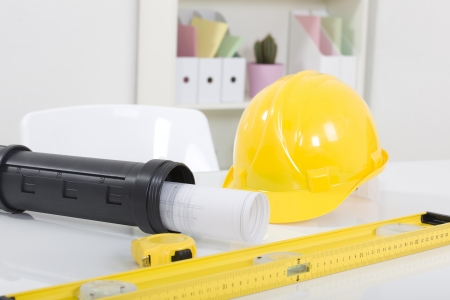Hardhat  and measuring instruments on blueprint