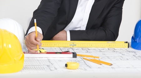 Architect at the table with blueprint