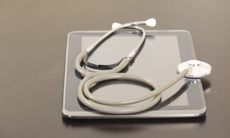 Doctor workplace with digital tablet and stethoscopeの写真素材