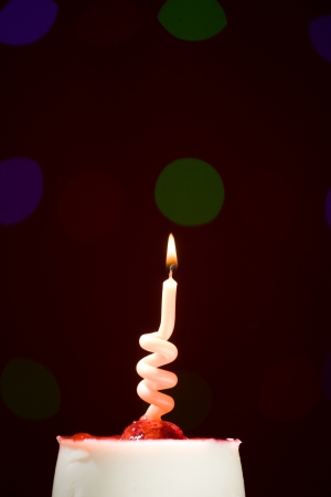 happy birthday cake shot on a red blurred background with candlesの写真素材