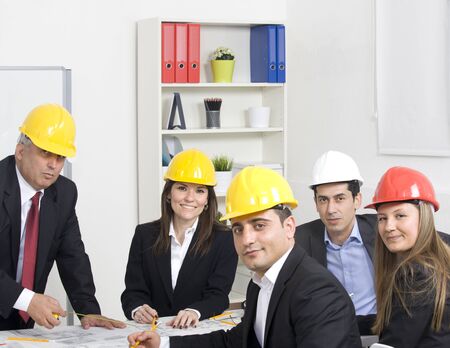 Architects working in office on construction project