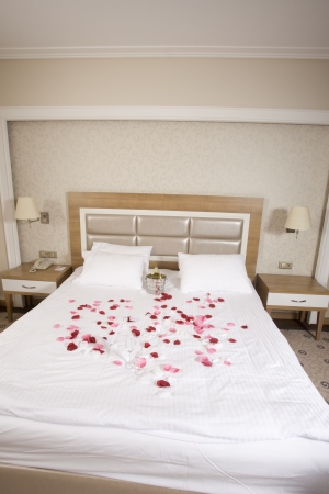 wine in bed to celebrate Valentine's Day at hotel roomの写真素材
