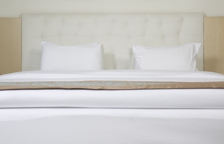King sized bed in a luxury hotel roomの写真素材
