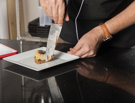 chef preparing cheese cake in the kitchenの写真素材