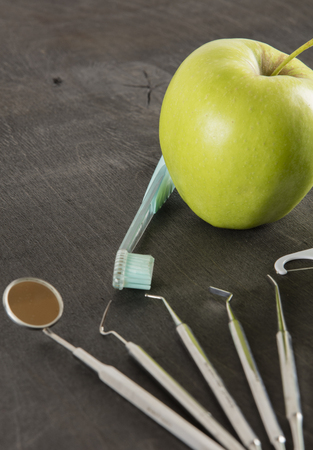 set of dentist tools on wooden backgroundの写真素材