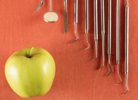 set of dentist tools on wooden backgroundの写真素材