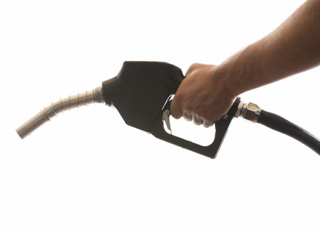 white car at gas station being filled with fuelの写真素材