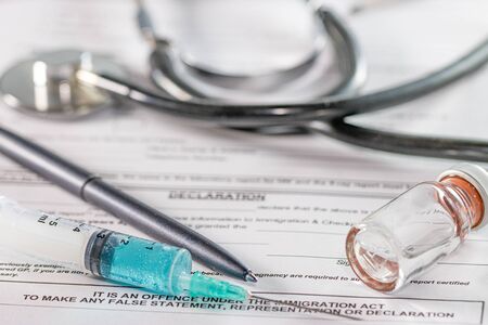 White background doctor office with stethoscope and blue injection