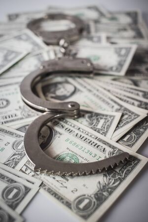 Handcuff above usa dollar. Theft, background