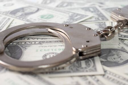 Handcuff above usa dollar. Theft, background