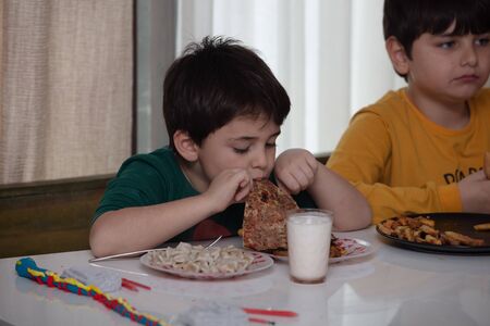 Traditional delicious Turkish food; Turkish lahmacun.The boy is eating it.の写真素材