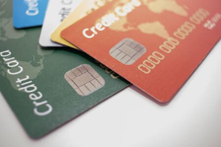 different color chipped credit card lying on white bacgroundの写真素材