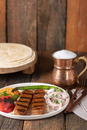 Turkish Adana Kebab with Vegetables on the Plateの写真素材