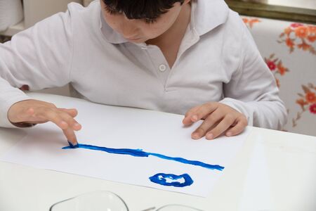 Child Finger Painting at home  On Paper at covid time . stay at homeの写真素材