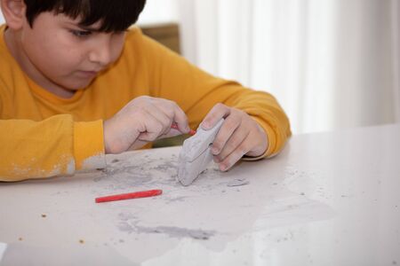 children's entertainment, a child plays in an archaeologist, children's hands dig dinosaur bonesの写真素材