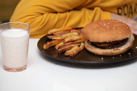 Kid Boy Eating Delicious homemade Hamburgerの写真素材