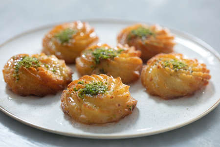 Turkish and Arabic Traditional Ramadan Dessert Lor Cheese Dessert with pistachio powder and syrup...