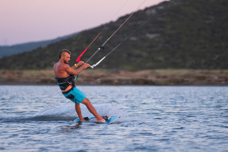 BAHCEKOY, URLA, IZMIR, TURKEY - JULY 30, 2023, People kite surf at the beach on a sunny afternoon in Gulbahce , Urla Izmir. High quality photoのeditorial素材