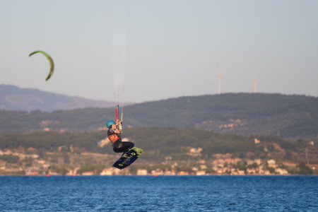 BAHCEKOY, URLA, IZMIR, TURKEY - JULY 30, 2023, People kite surf at the beach on a sunny afternoon in Gulbahce , Urla Izmir. High quality photoのeditorial素材