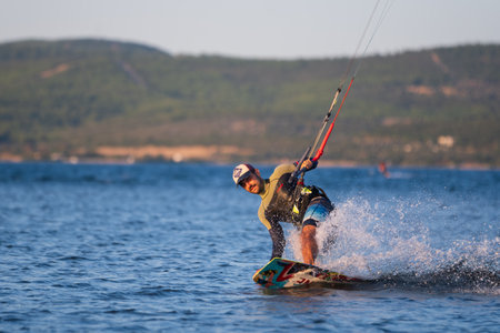 Gulbahce,Urla,Izmir,Turkey - July 30, 2023, People kite surf at the beach on a sunny afternoon in Gulbahce , Urla Izmir. High quality photoのeditorial素材