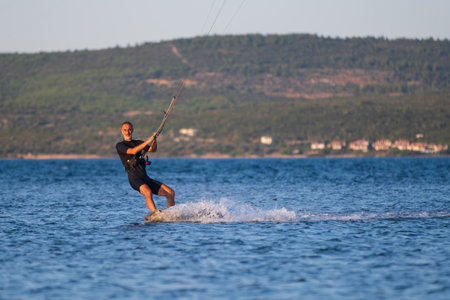 Gulbahce,Urla,Izmir,Turkey - July 30, 2023, People kite surf at the beach on a sunny afternoon in...