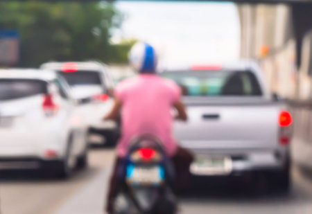 Abstract blur car and motorcycle driving on road with traffic jam in the city.の写真素材