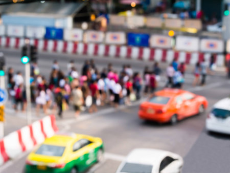 abstract blur the people walking on zebra crossing and traffic jam in the city.の写真素材