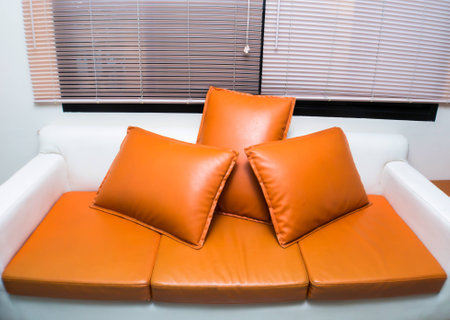 orange and white sofa furniture in living room.の写真素材