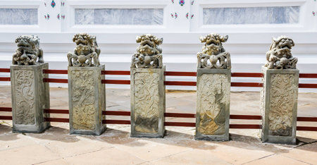 chinese lion statue on the wall of buddhist temple in thailand.の写真素材