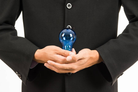 Businessman holding light bulb in creativity concept.の写真素材