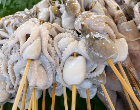 Raw octopuses at a marketの写真素材