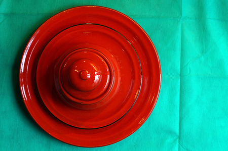 Red Sugar Bowl is on a saucer and on a plateの写真素材