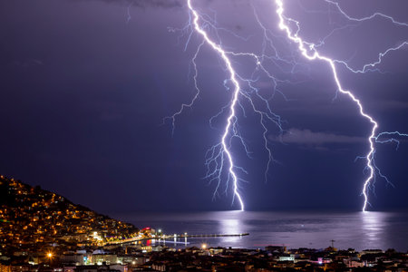 Lightning in the night sky over the cityの写真素材