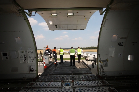 Open cargo compartment door of an airplane at the airport