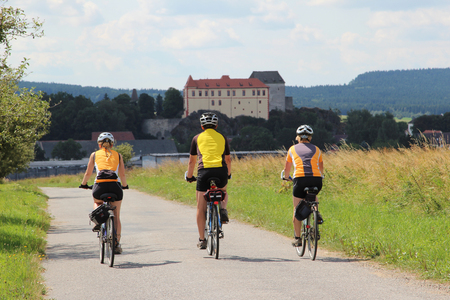 Three cyclists on the bike pathの写真素材