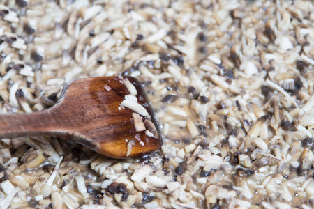 Wooden spoon with fried mushrooms の写真素材
