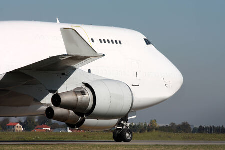 The nose of a large white taxiing plane at the airportの写真素材