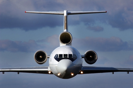 Front view of the three-engine aircraft in flightの写真素材