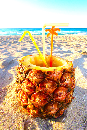 Pina Colada drink in fresh pineapple on the beachの写真素材