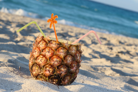 Pina Colada drink in fresh pineapple on the beachの写真素材