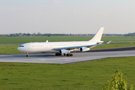 All white plane on the airport runwayの写真素材