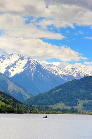Fishermen on the Zeller See with beautiful mountains in the backgroundの写真素材