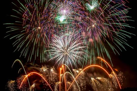 New Year celebrations - Colorful fireworks on the black backgroundの写真素材
