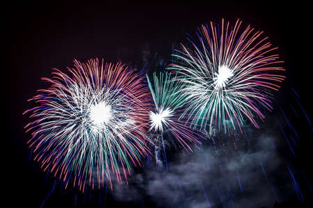 New Year celebrations - Colorful fireworks on the black backgroundの写真素材