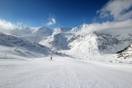 Beautiful scenery groomed slopes, snow-capped peaks of the Austrian Alps in the backgroundの写真素材