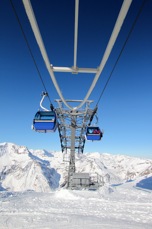Gondola lift in the Austrian Alps with beautiful blue skyの写真素材