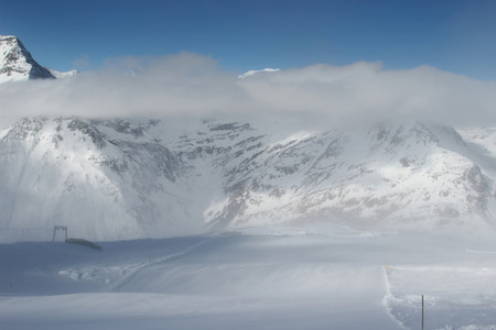 Beautiful scenery groomed slopes, snow-capped peaks of the Austrian Alps in the backgroundの写真素材