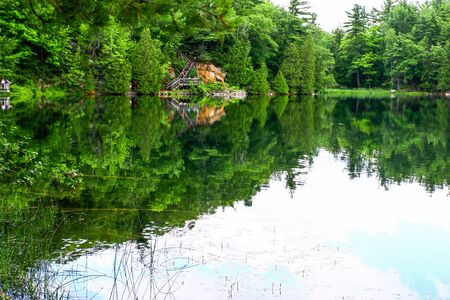 Gatineau pink lake with reflection from the sky on the waterの写真素材